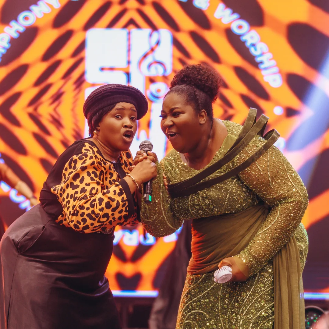 Two singers sharing a microphone on the SPAW stage